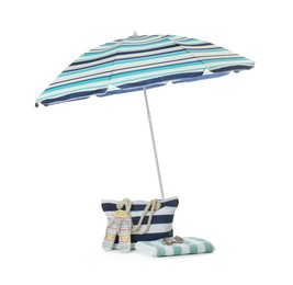 Photo of Open blue striped beach umbrella and accessories on white background