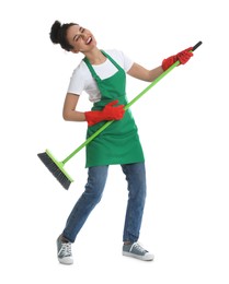 Photo of African American woman with green broom singing on white background