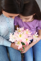 Photo of Little daughter congratulating her mom, above view. Happy Mother's Day