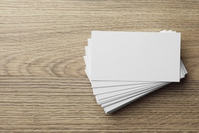 Photo of Blank business cards on wooden table, top view. Mockup for design
