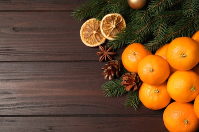 Flat lay Christmas composition with fresh tangerines on wooden table. Space for text