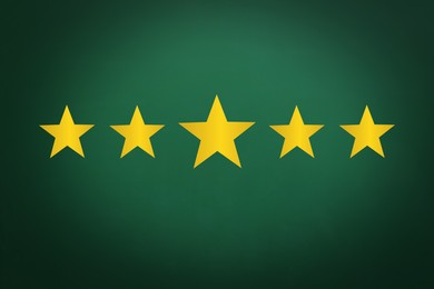 Image of Quality evaluation. Golden stars on green chalkboard