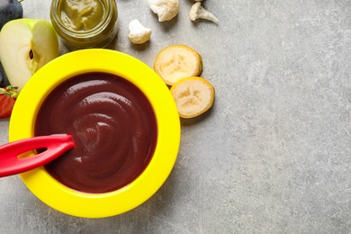 Photo of Healthy baby food on grey table, flat lay. Space for text