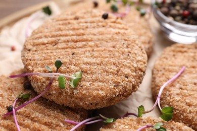 Tasty vegan cutlets with breadcrumbs on table, closeup
