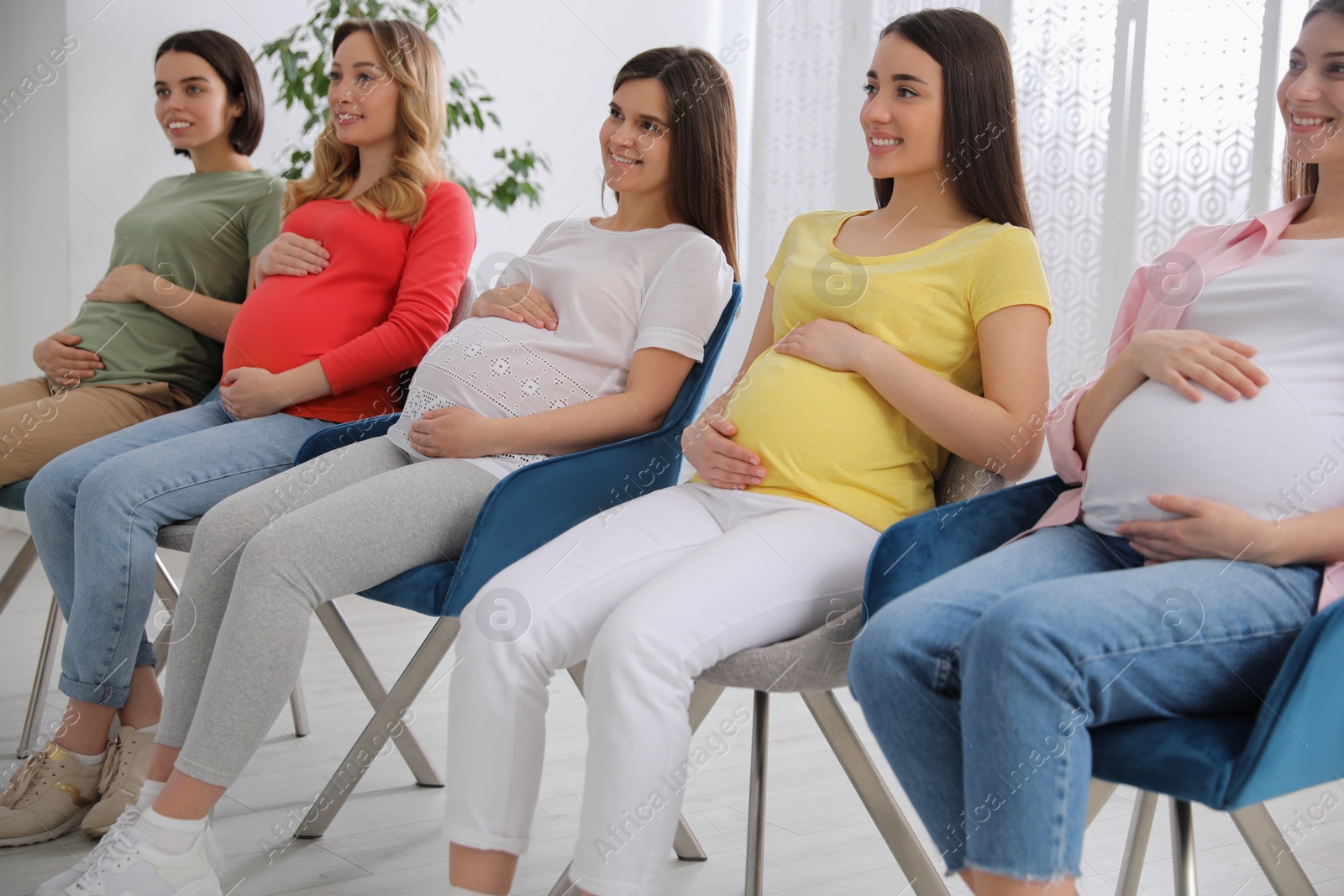 Photo of Group of pregnant women at courses for expectant mothers indoors