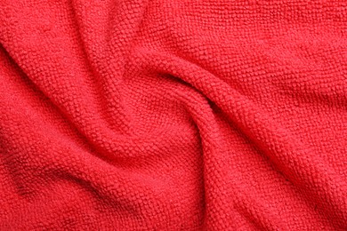 Crumpled red microfiber cloth as background, closeup