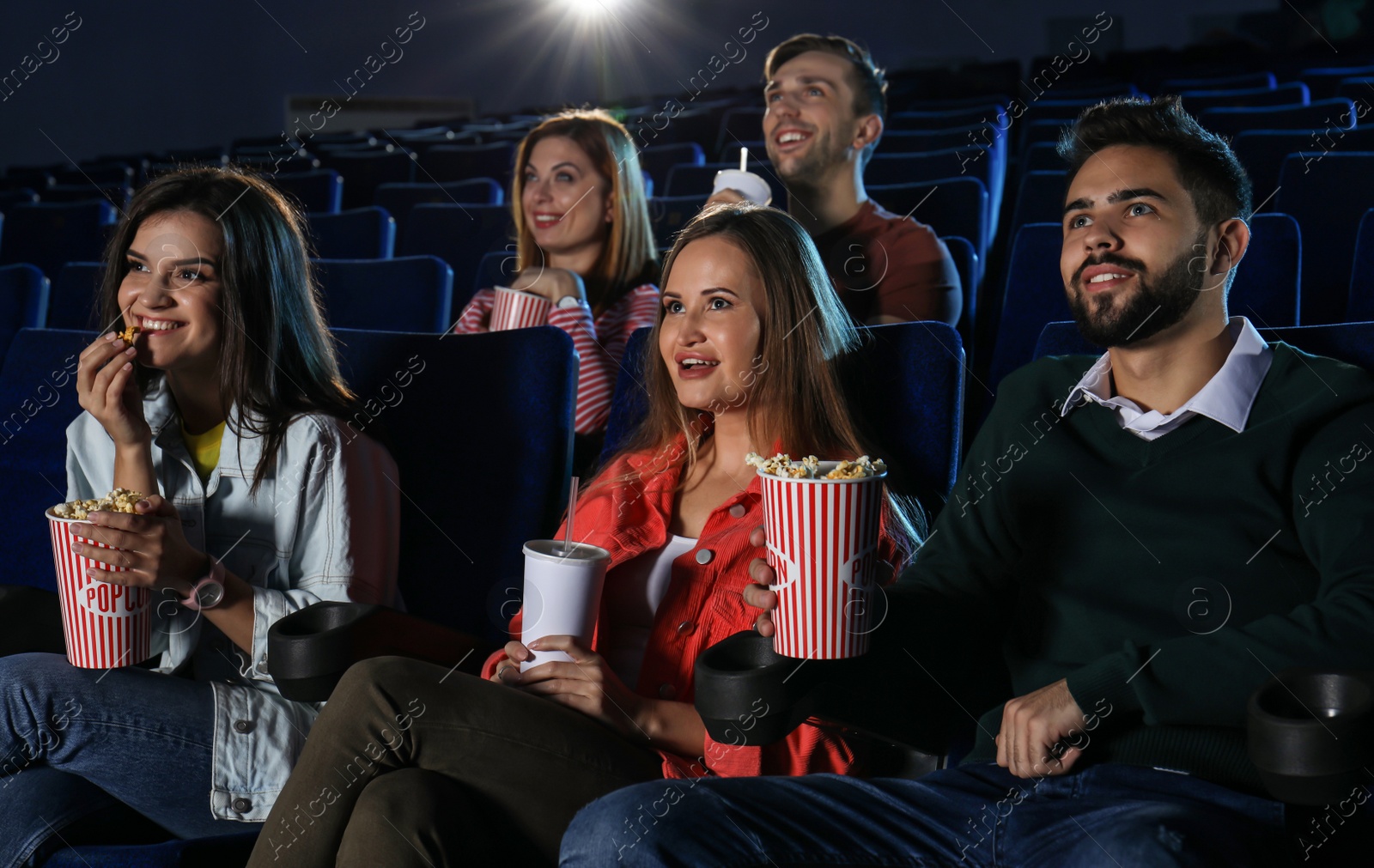 Photo of Young people watching movie in cinema theatre