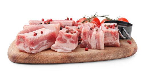 Photo of Cut raw pork ribs with peppercorns, tomatoes and sauce isolated on white