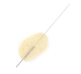 One needle for acupuncture and stone on white background, top view