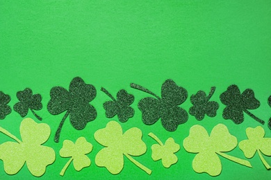 Flat lay composition with clover leaves on light green background, space for text. St. Patrick's Day celebration