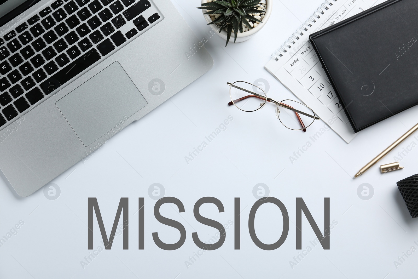 Image of Laptop, stationery and text MISSION on white background, flat lay