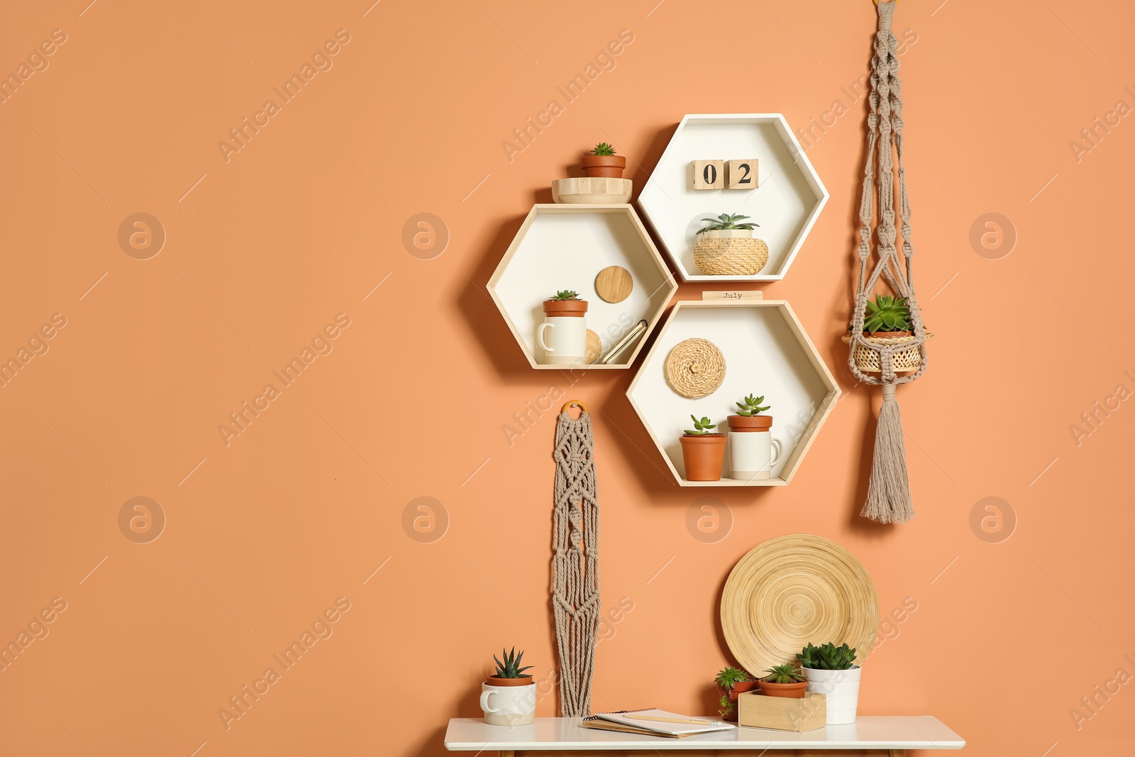 Photo of Shelves and table with decorative elements on color wall. Space for text