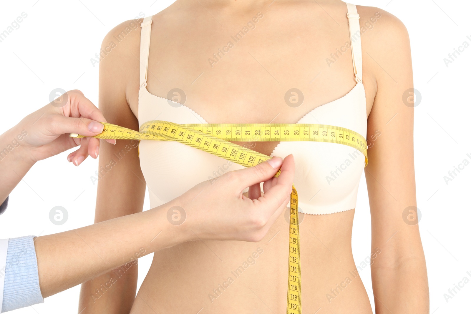 Photo of Doctor measuring size of patient's breast on white background, closeup. Cosmetic surgery