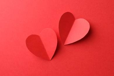 Photo of Paper hearts on red background, flat lay