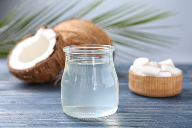 Coconut oil on blue wooden table, closeup view