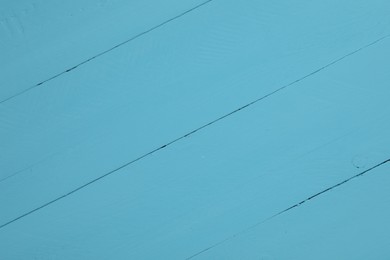 Texture of light blue wooden surface as background, closeup