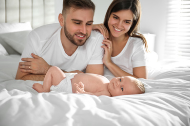 Happy couple with their newborn baby at home