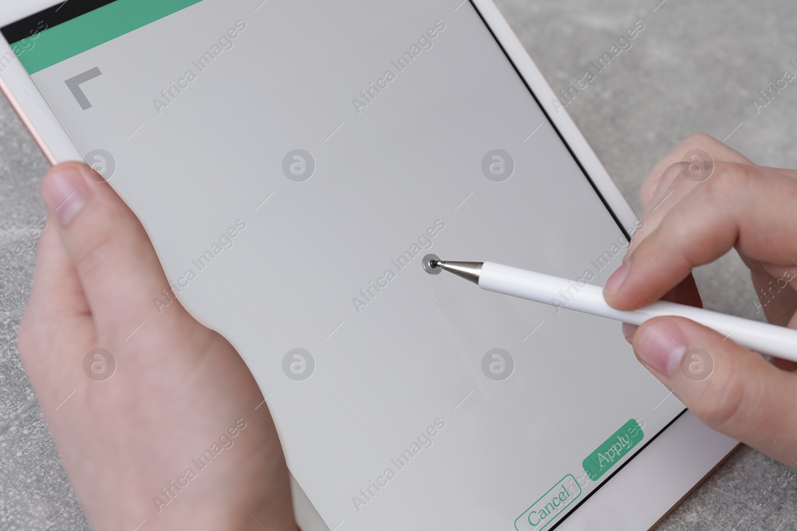 Image of Electronic signature. Man using stylus and tablet at table, closeup