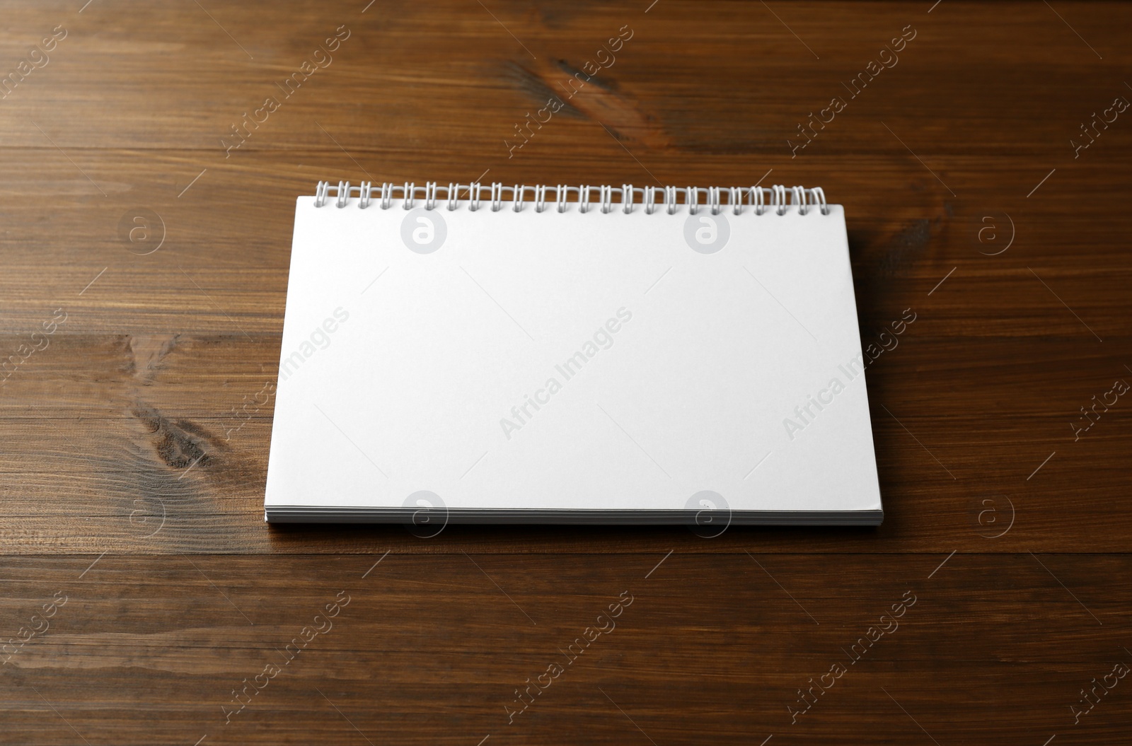 Photo of Blank paper brochure on wooden table. Mockup for design