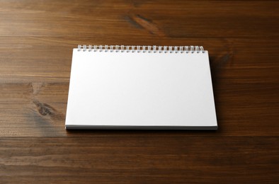 Blank paper brochure on wooden table. Mockup for design