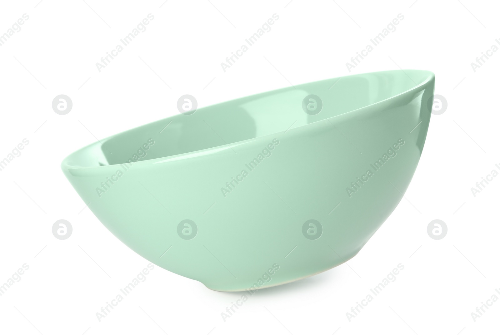 Photo of Clean light green bowl isolated on white