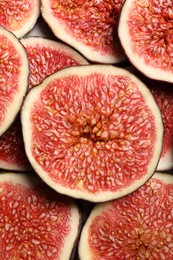 Photo of Pieces of fresh ripe figs on table, top view