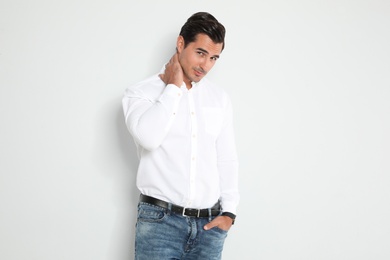 Portrait of handsome young man on light background