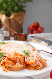 Photo of Delicious pasta with tomato sauce, chicken and parmesan cheese on white wooden table