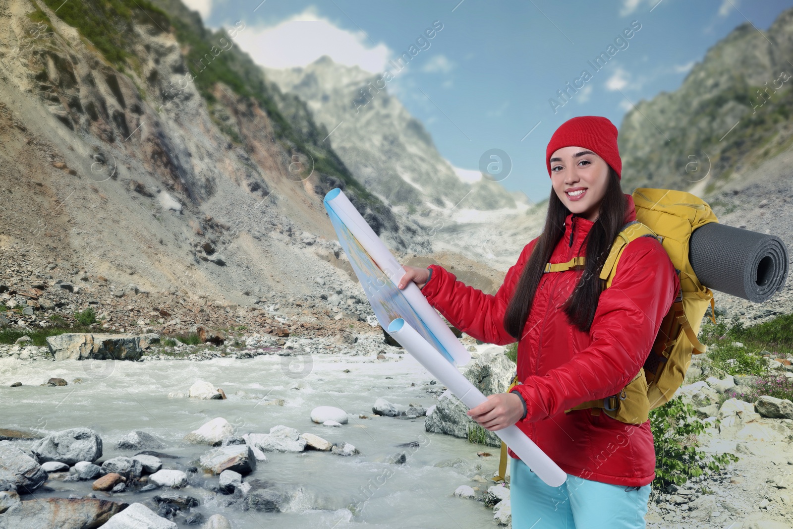 Image of Tourist with backpack and map in mountains