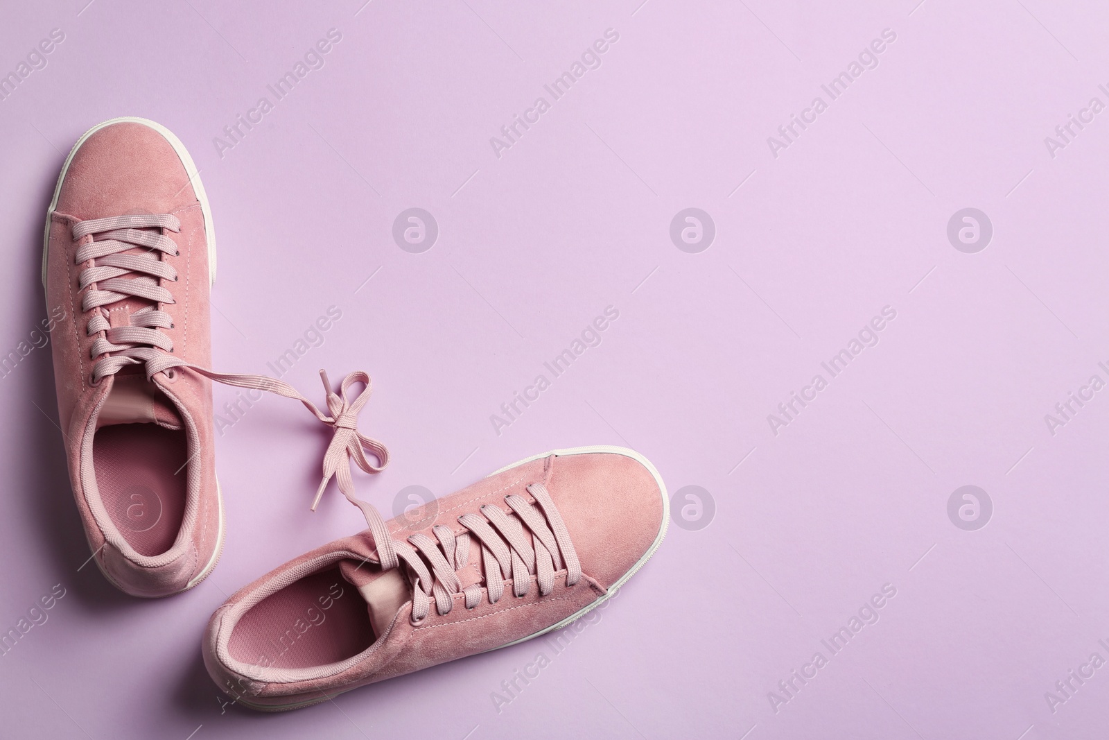 Photo of Bright stylish shoes on color background, top view. Space for text