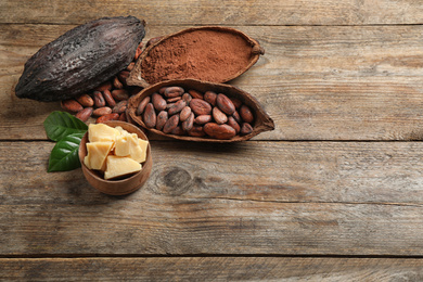 Composition with organic cocoa butter on wooden table, above view. Space for text