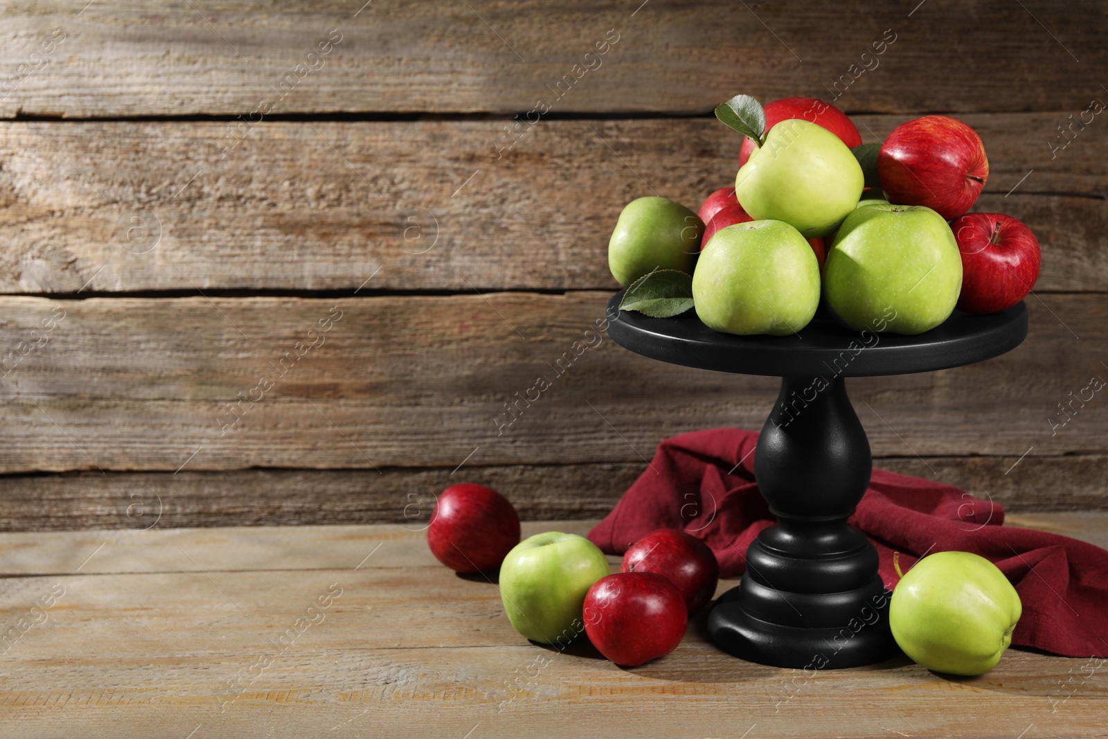 Photo of Fresh ripe red and green apples on wooden table. Space for text
