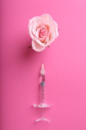 Photo of Cosmetology. Medical syringe and rose flower on pink background, flat lay
