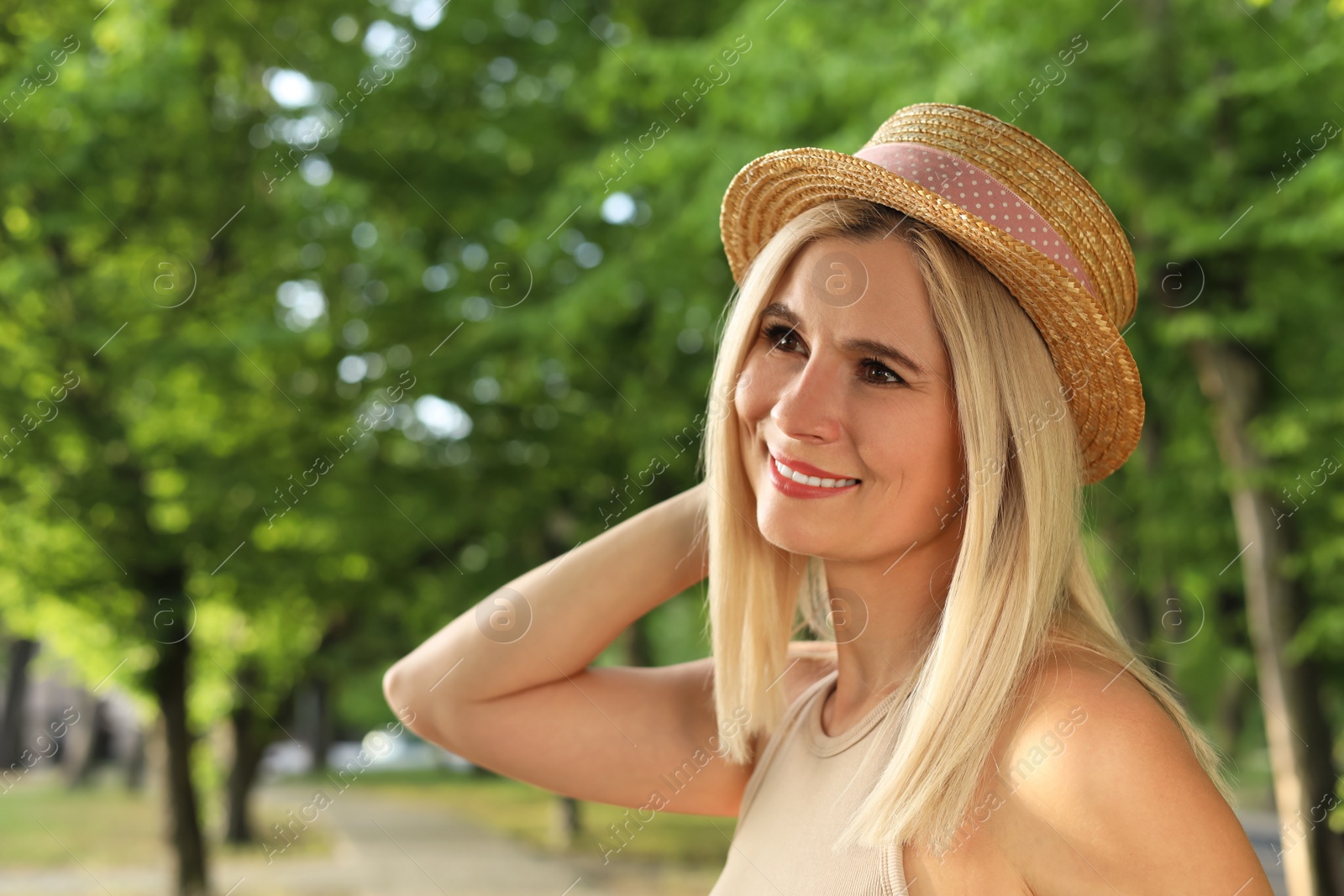 Photo of Portrait of beautiful woman in straw hat outdoors on sunny day