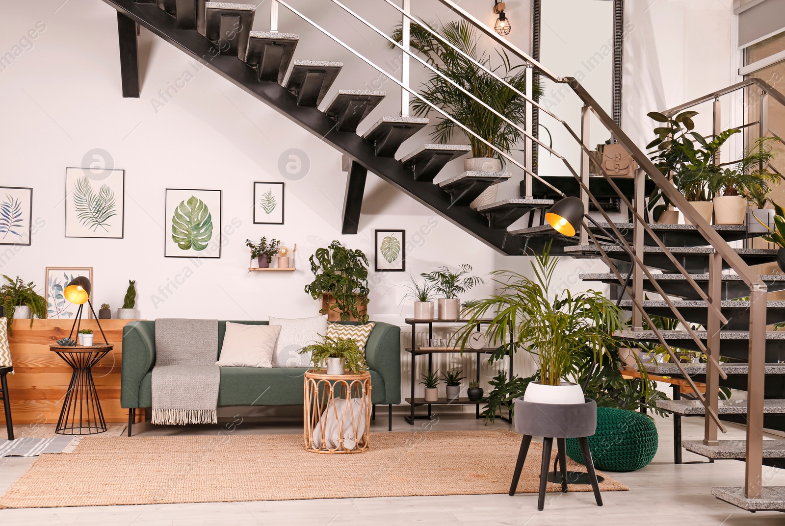 Photo of Stylish living room interior with comfortable sofa and green plants