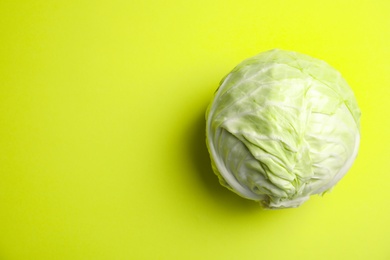 Photo of Ripe cabbage on color background, top view