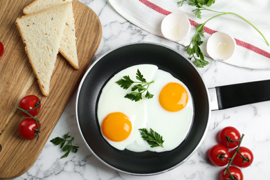 Photo of Flat lay composition with tasty fried chicken eggs on white marble table