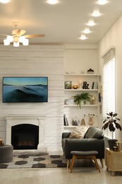 Photo of Cozy living room interior with comfortable sofa and decorative fireplace