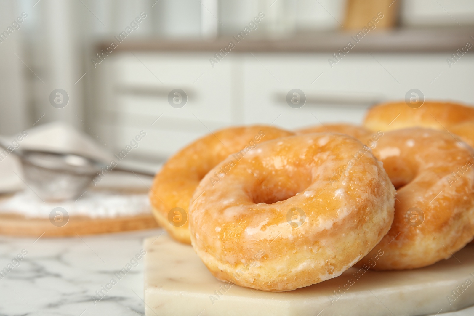 Photo of Delicious donuts on marble table. Space for text