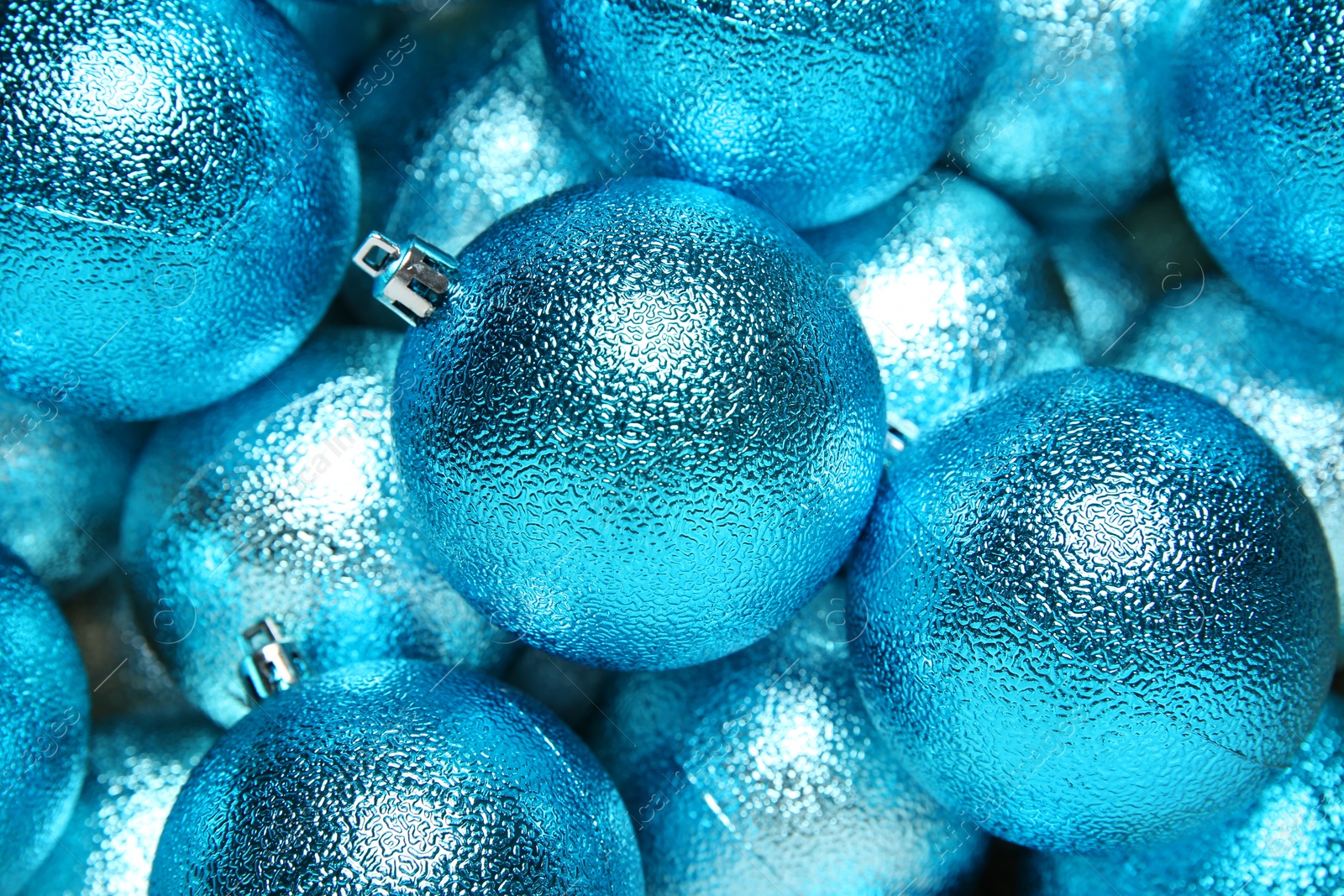 Photo of Light blue Christmas balls as background, closeup