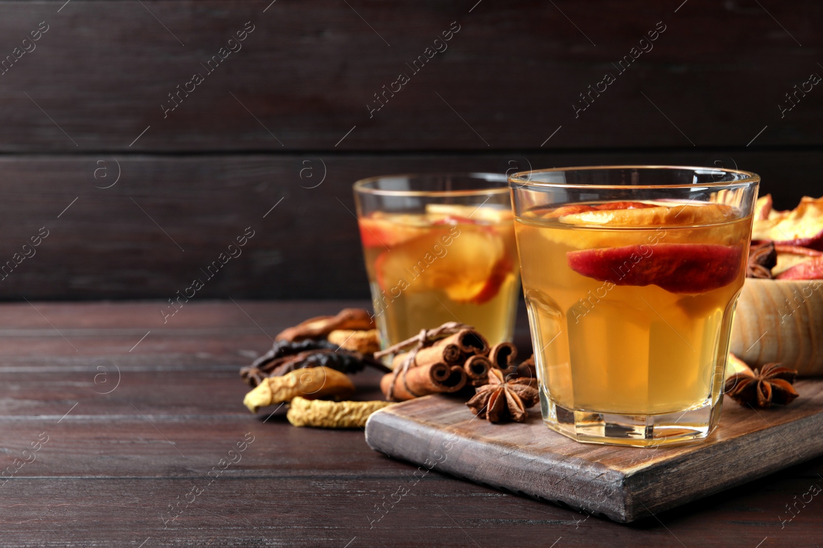 Photo of Delicious compote and ingredients on wooden table, space for text