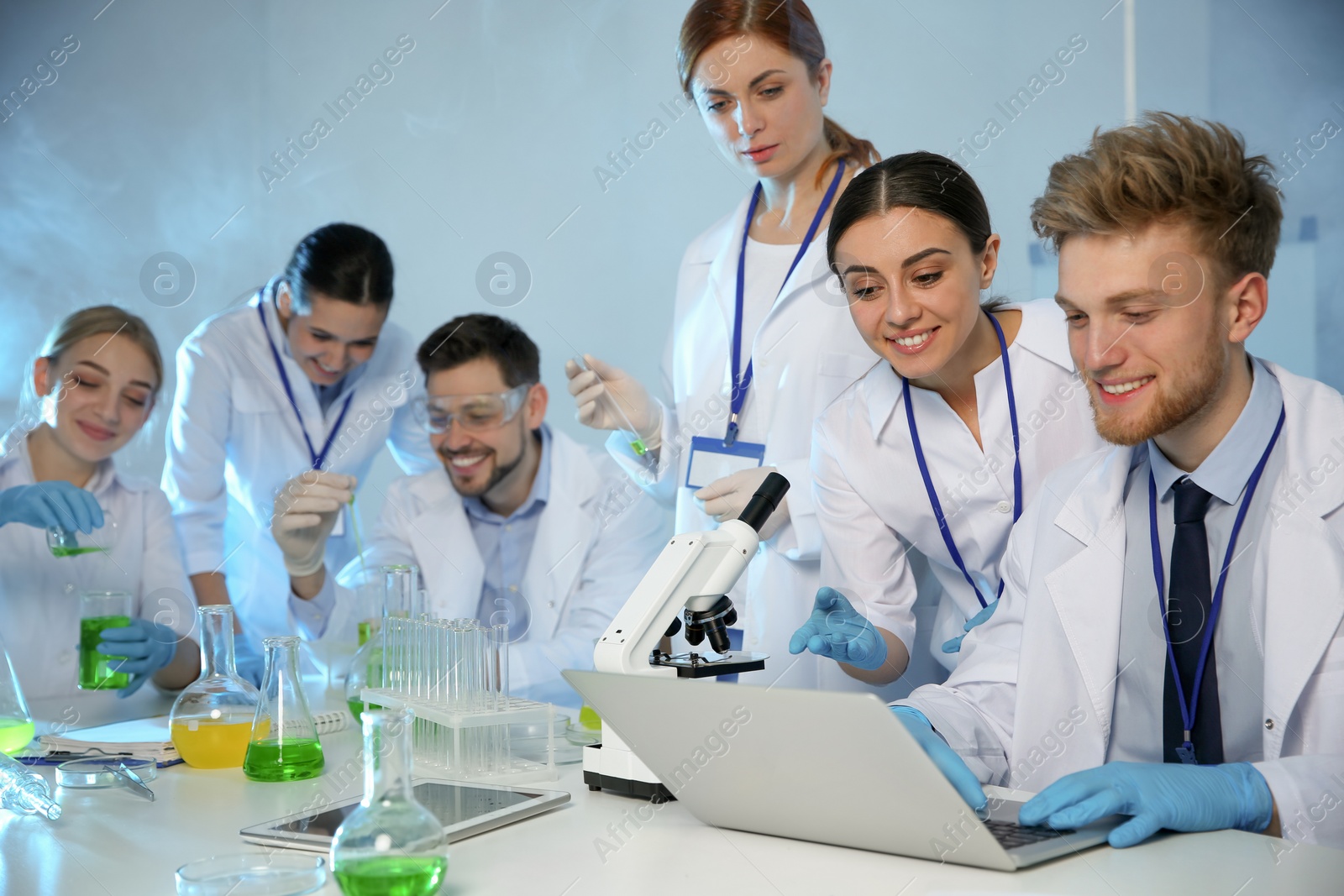 Photo of Group of scientists working in modern chemistry laboratory