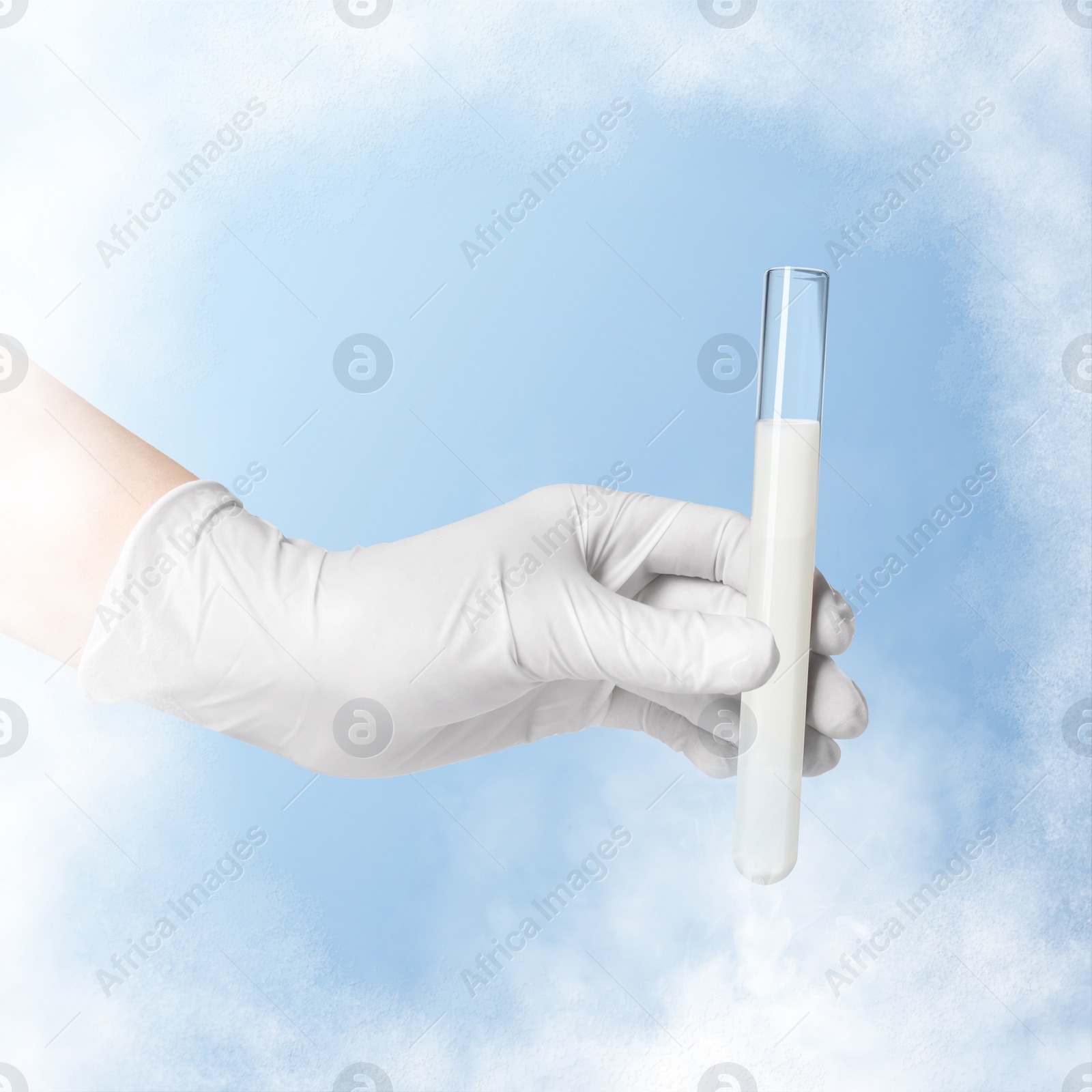 Image of Cryopreservation. Laboratory assistant holding test tube with sperm on light blue background, closeup. Frost effect