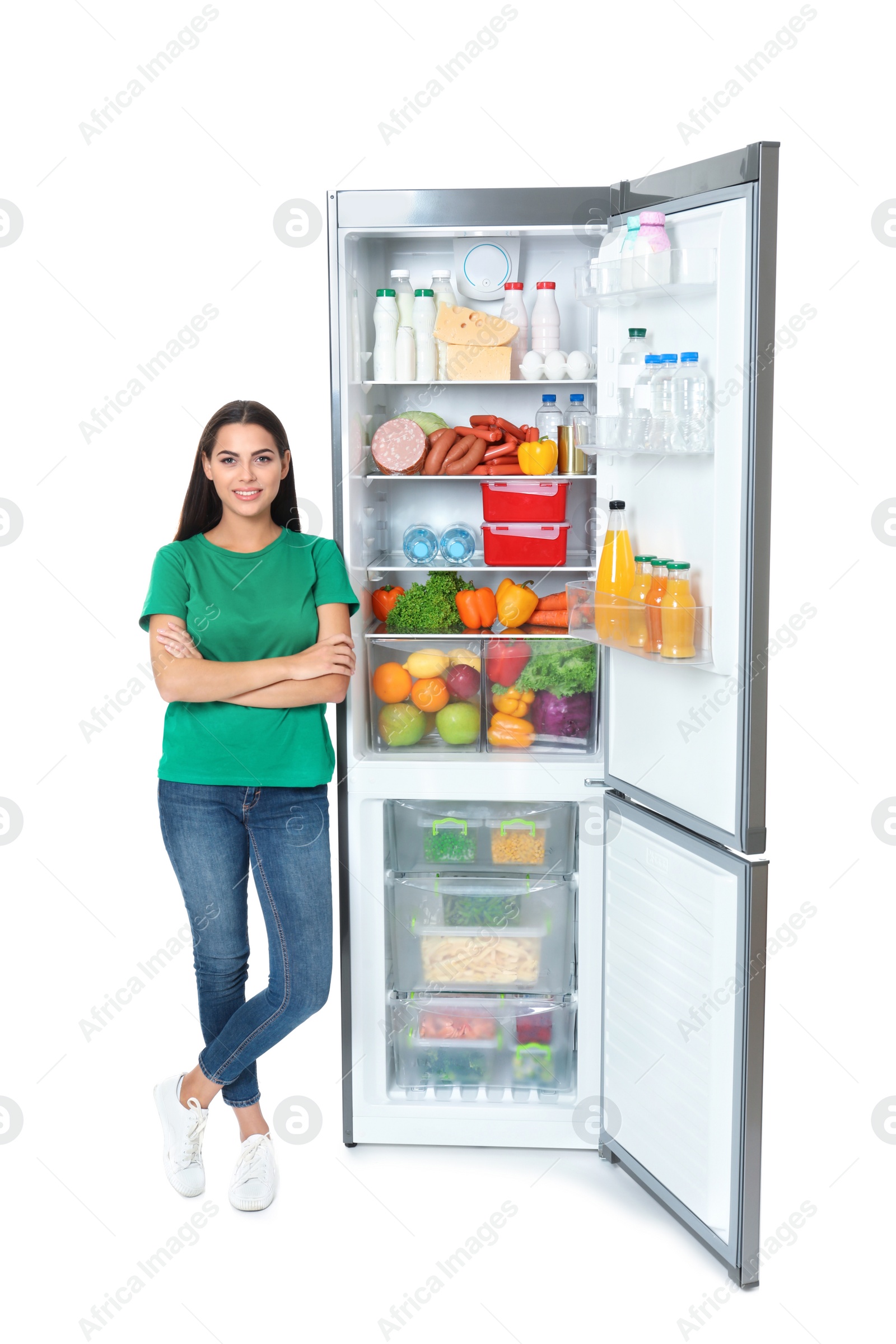 Photo of Young woman near open refrigerator on white background