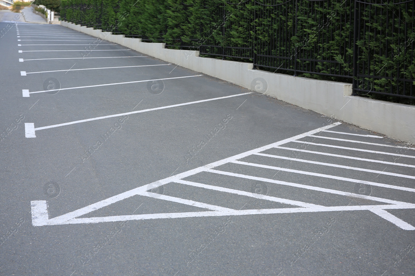 Photo of Empty outdoor parking lot with painted markings on asphalt