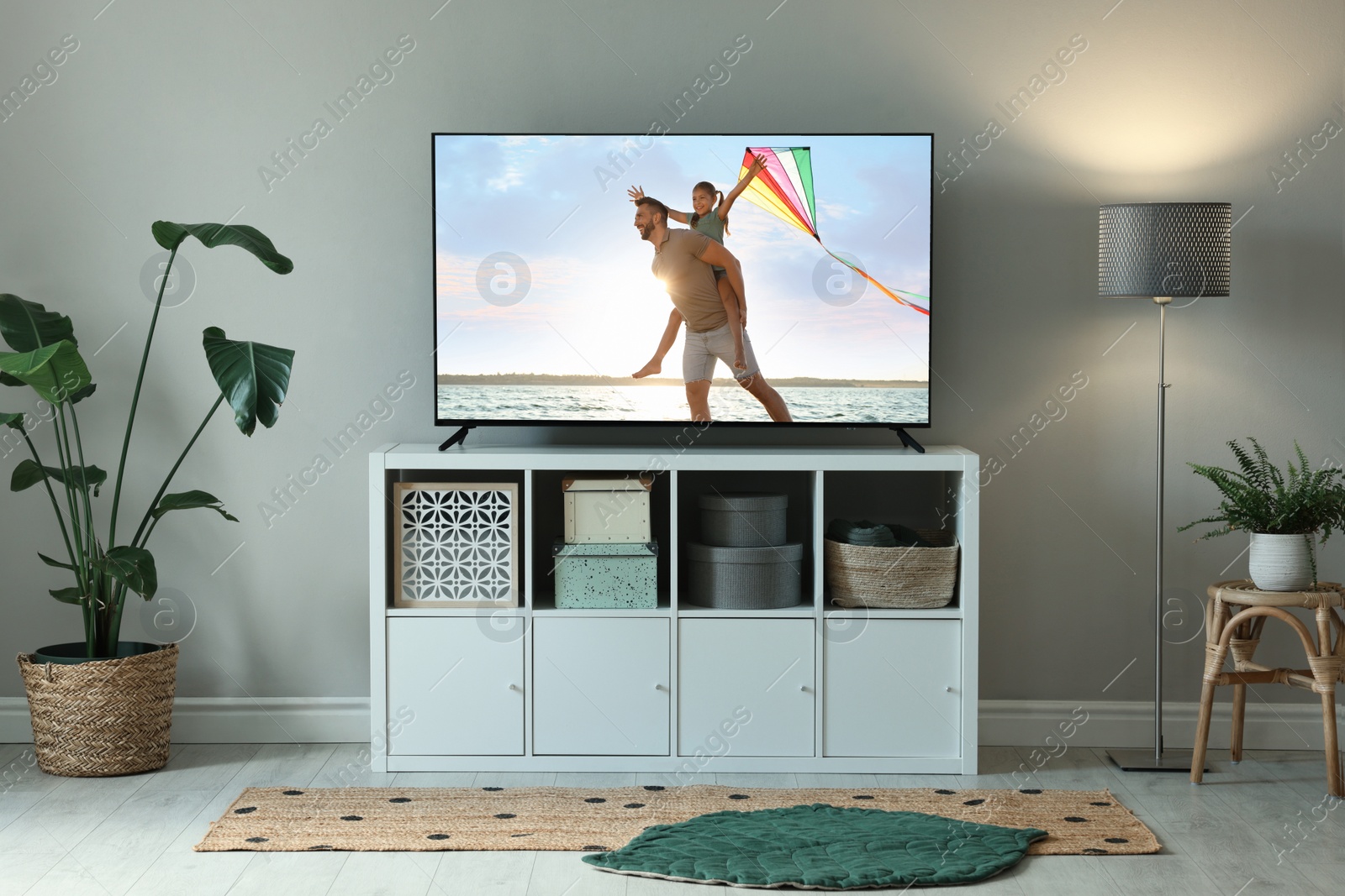 Image of Modern TV set on wooden stand in room