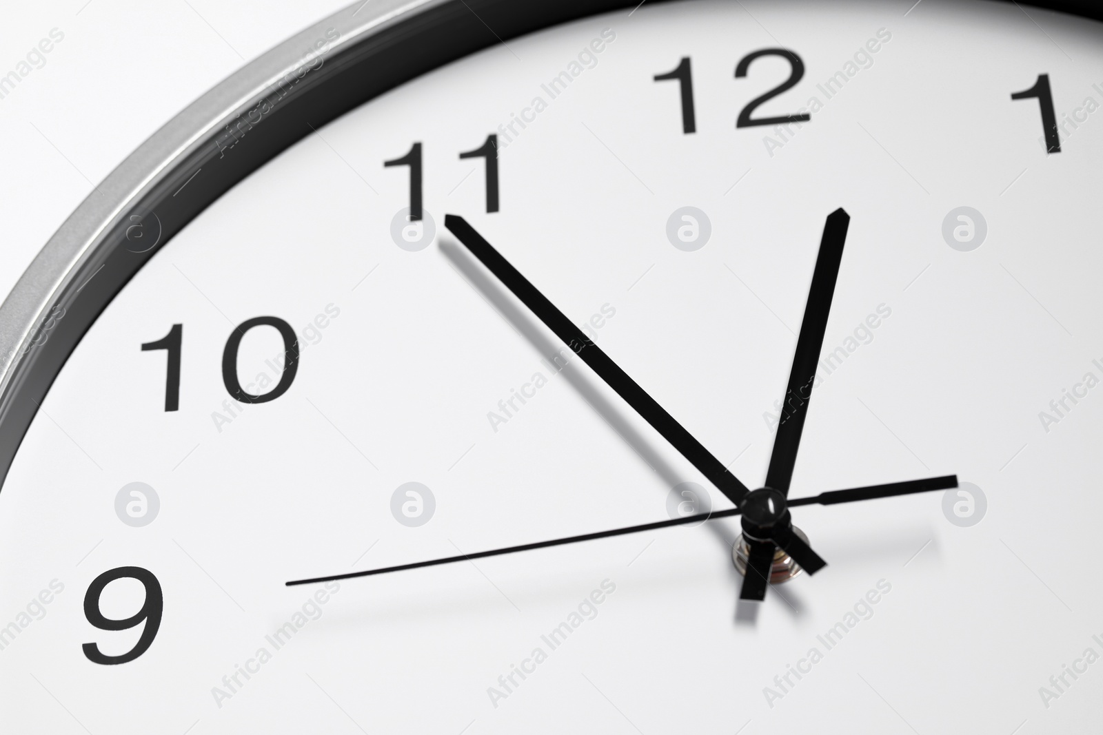 Photo of Stylish round clock on white background, closeup. Interior element