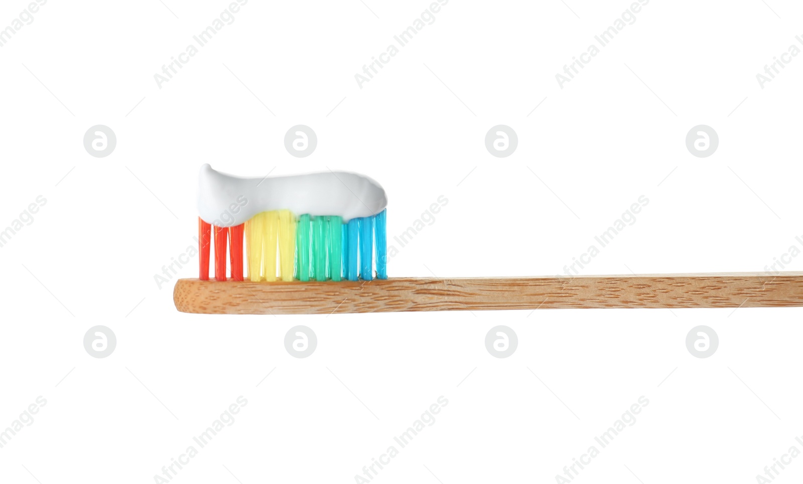 Photo of Bamboo toothbrush with paste on white background. Dental care