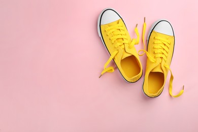 Pair of trendy sneakers on pink background, flat lay. Space for text