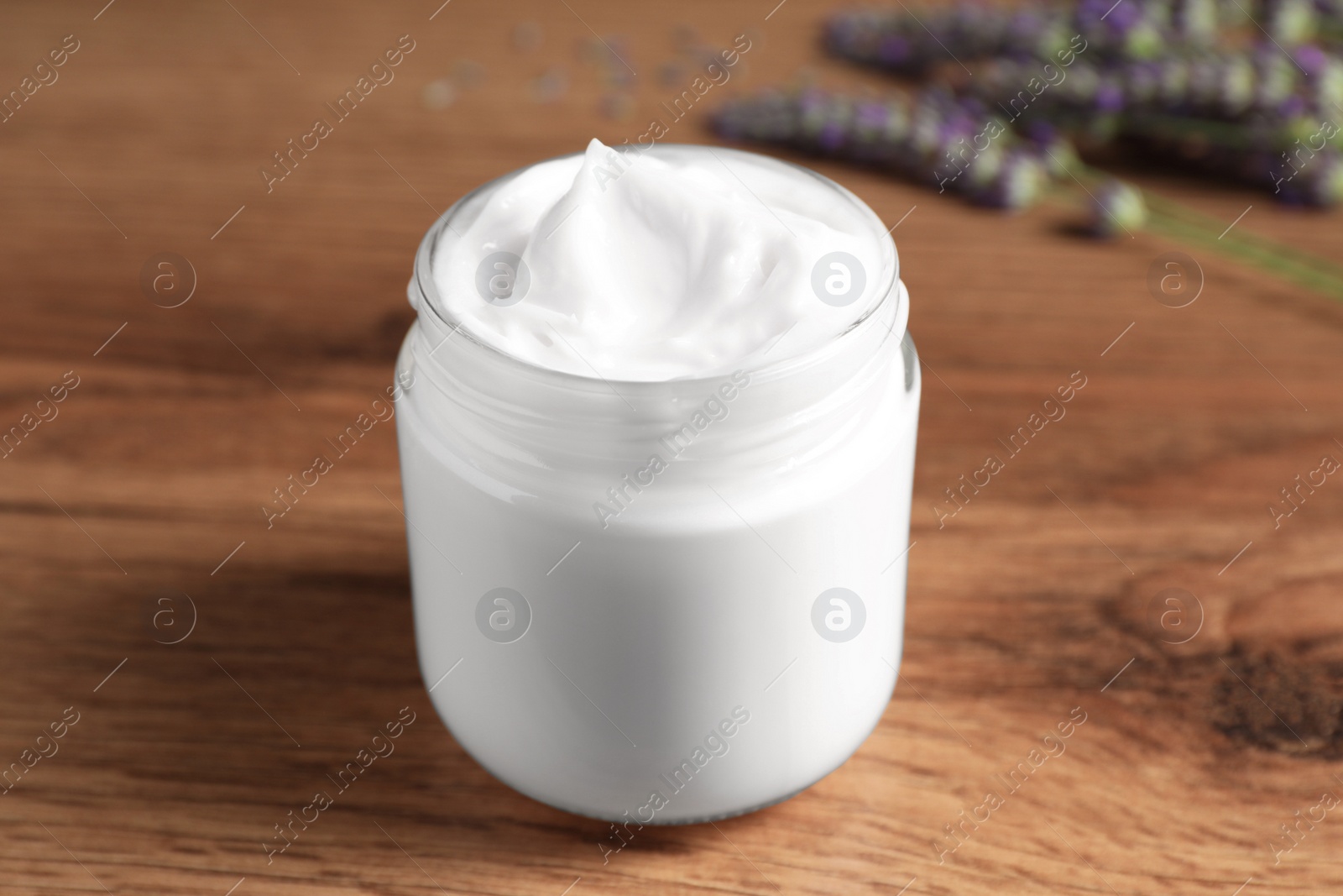 Photo of Jar of face cream on wooden table, closeup